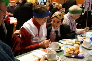 Student and local resident enjoy bingo at Trinity Community Christmas Party